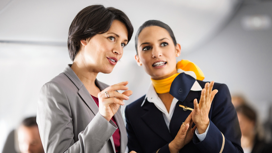 A Lufthansa employee talking to a customer